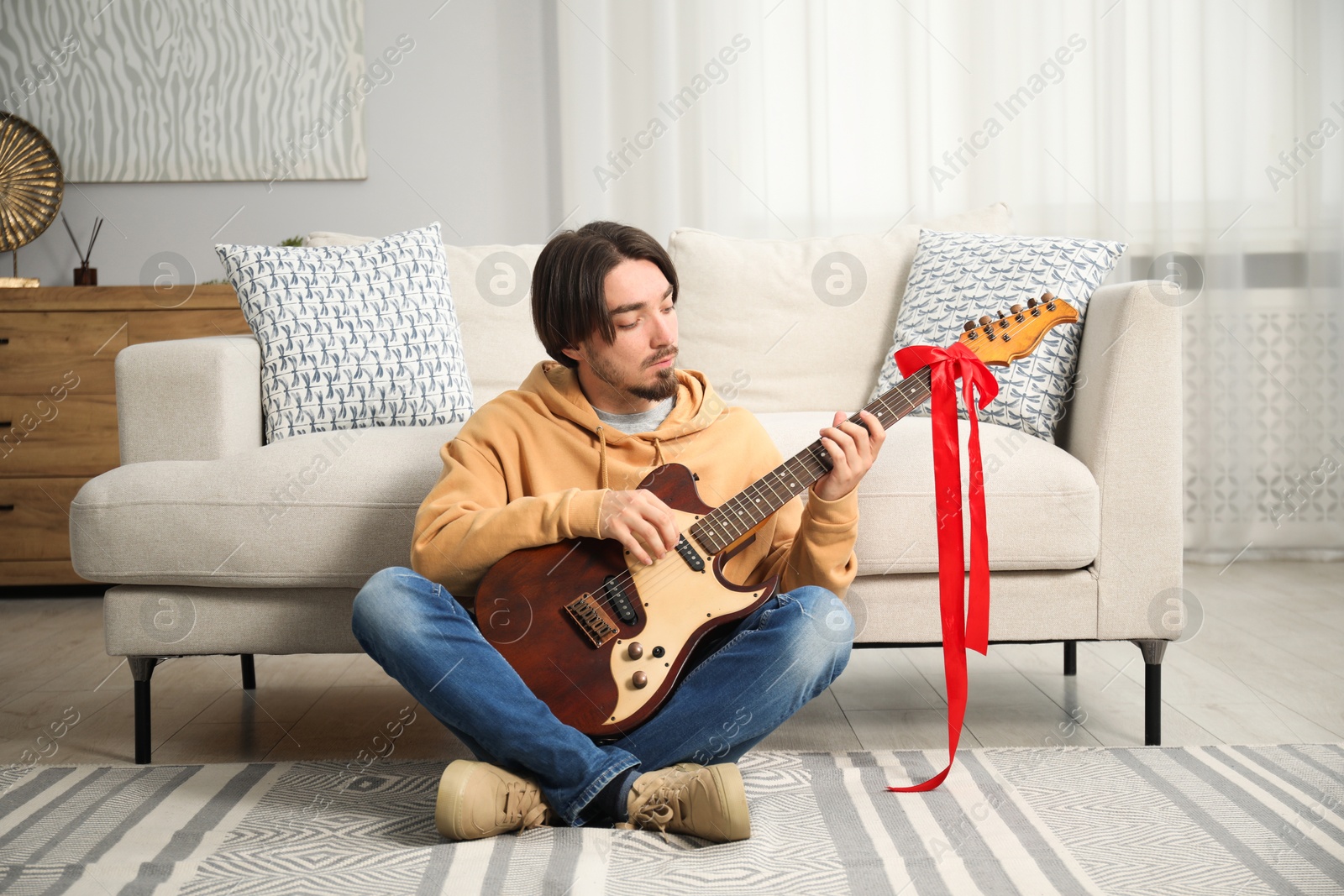 Dreams come true. Happy man with guitar at home Photo of Dreams come true. Happy man with guitar at home
