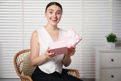 Photo of Dreams come true. Happy woman with gift at home