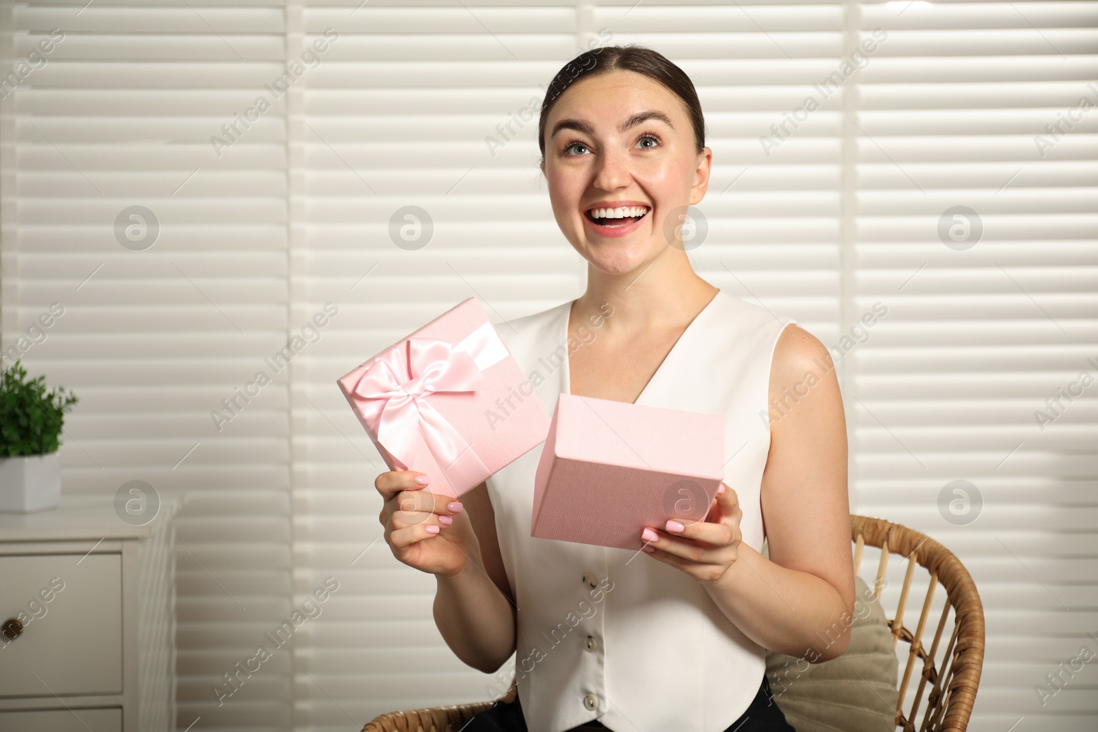 Dreams come true. Happy woman with gift at home Photo of Dreams come true. Happy woman with gift at home
