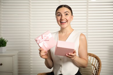 Photo of Dreams come true. Happy woman with gift at home