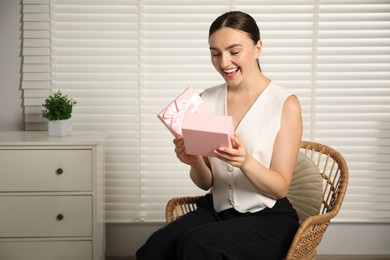 Photo of Dreams come true. Happy woman with gift at home