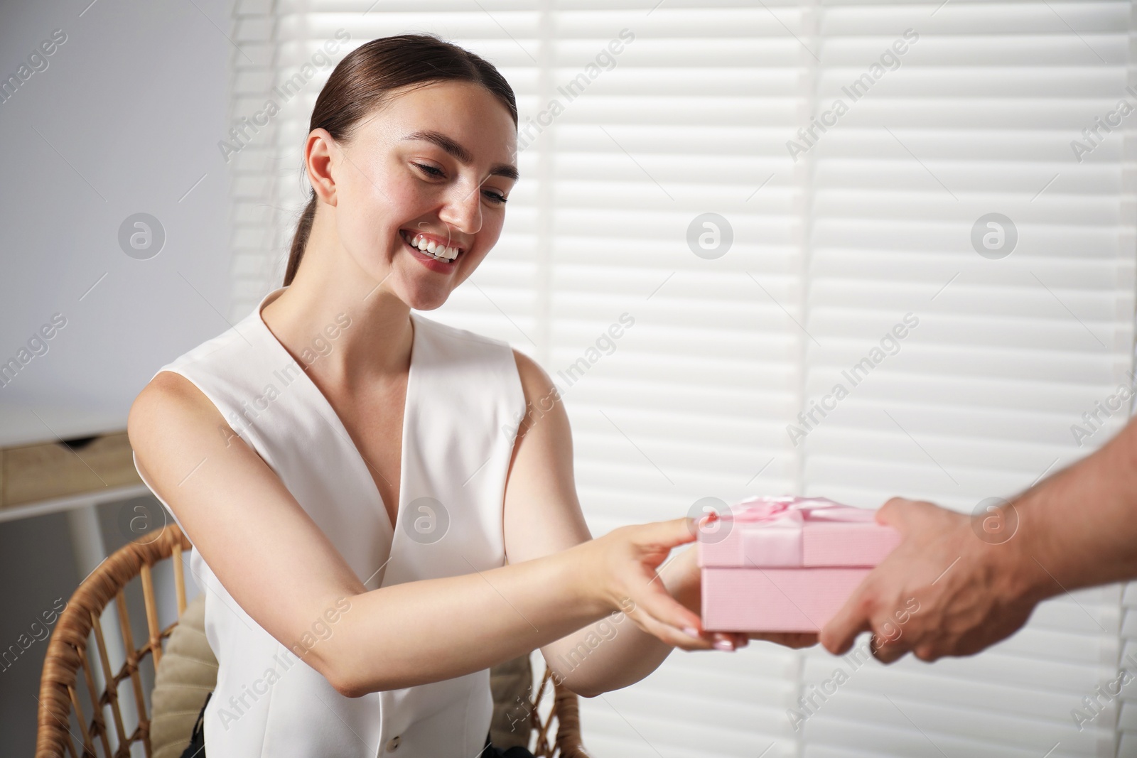 Dreams come true. Man surprising woman with gift at home, closeup. Space for text Photo of Dreams come true. Man surprising woman with gift at home, closeup. Space for text