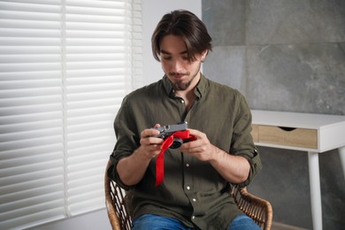 Photo of Dreams come true. Man with new gifted camera at home