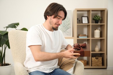 Photo of Dreams come true. Man with gift at home