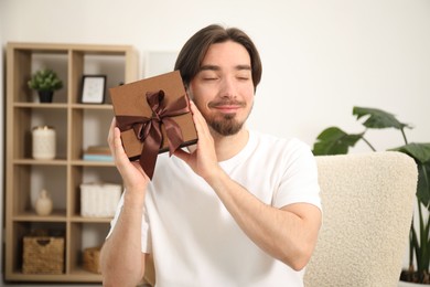 Photo of Dreams come true. Man with gift at home