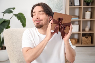 Photo of Dreams come true. Man with gift at home
