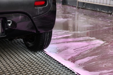 Photo of Clean auto after washing at outdoor car wash, closeup. Space for text