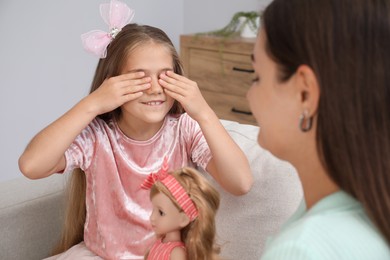 Photo of Dreams come true. Mother giving doll to her daughter at home