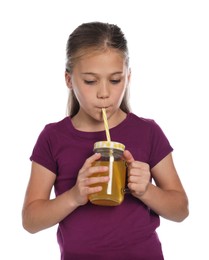 Photo of Little girl drinking juice through straw on white background