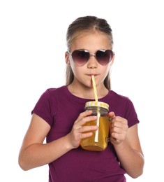 Photo of Little girl drinking juice through straw on white background
