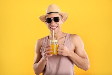 Photo of Man with juice and drinking straw on orange background