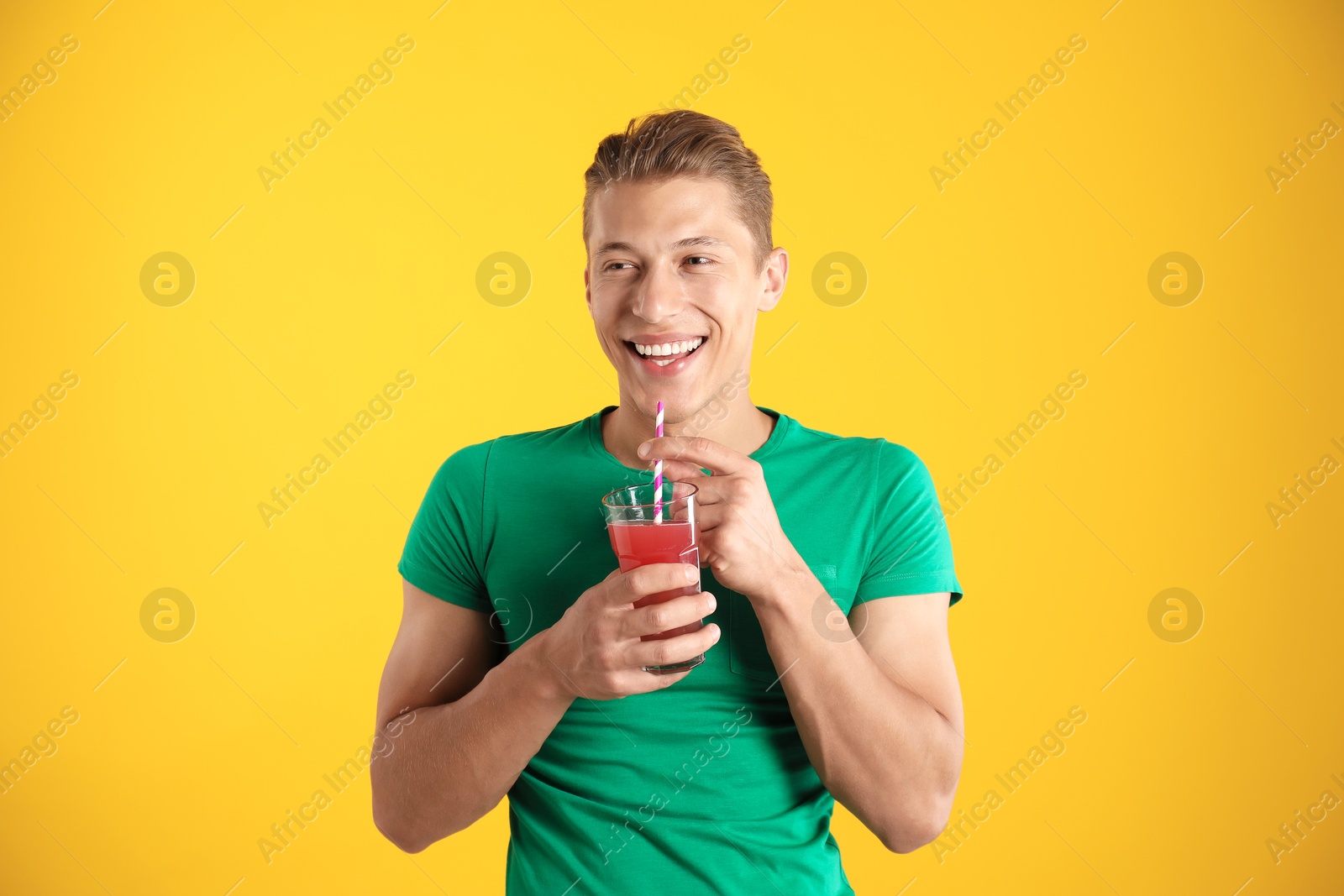 Photo of Man with juice and drinking straw on orange background