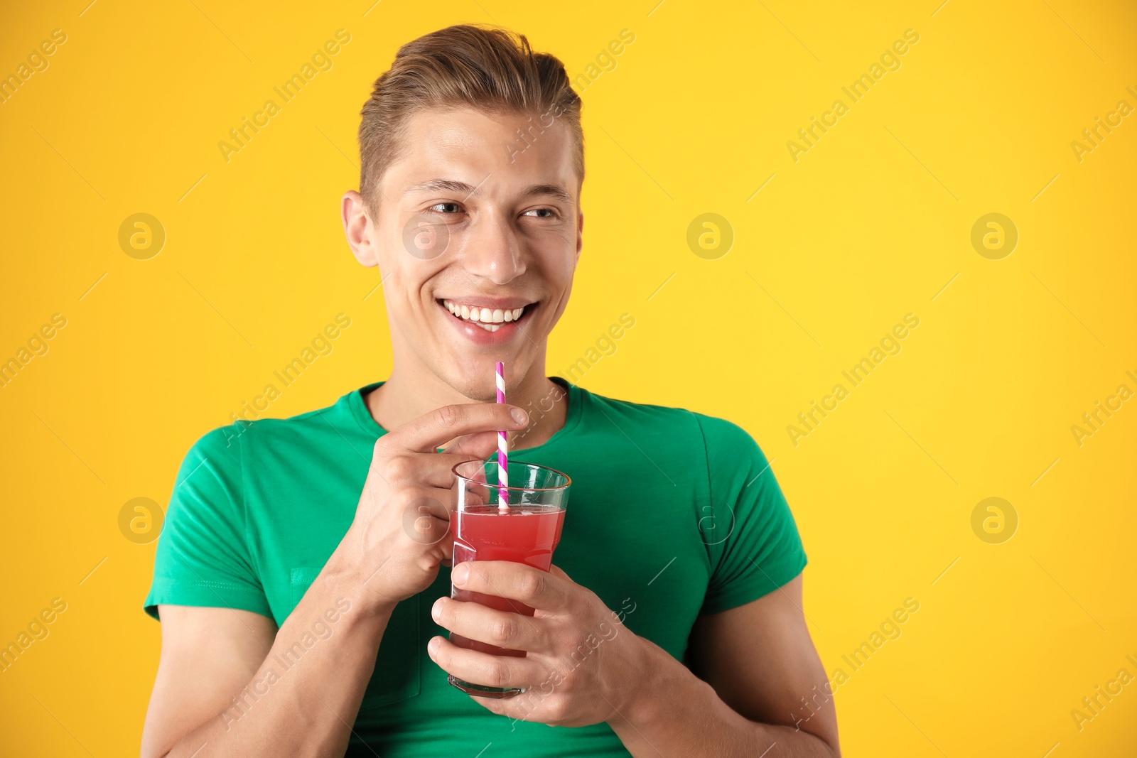 Photo of Man with juice and drinking straw on orange background