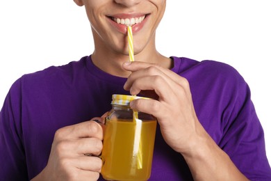 Photo of Man drinking juice through straw on white background, closeup