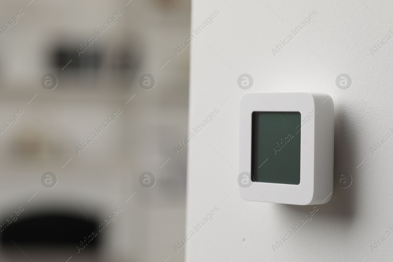 Photo of One thermostat on white wall indoors, space for text. Smart home system