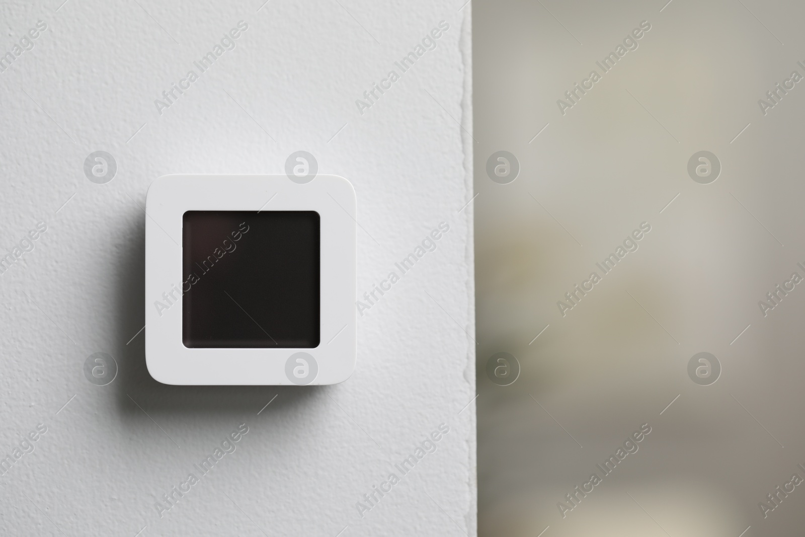 One thermostat on white wall indoors, space for text. Smart home system Photo of One thermostat on white wall indoors, space for text. Smart home system