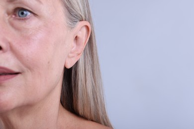 Photo of Woman with healthy skin on light background, closeup. Space for text