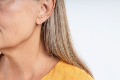 Photo of Woman with healthy skin on light background, closeup. Space for text