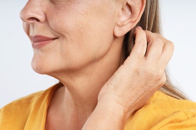 Photo of Woman with healthy skin on light background, closeup
