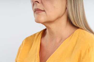 Photo of Woman with healthy skin on light background, closeup