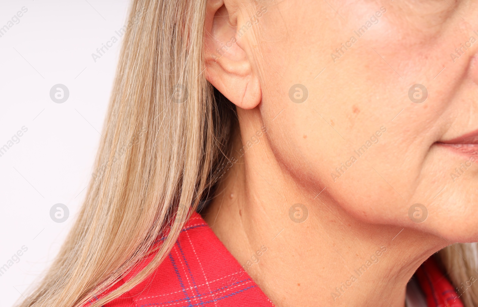 Woman with healthy skin on light background, closeup Photo of Woman with healthy skin on light background, closeup