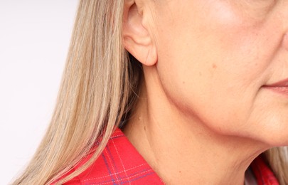 Photo of Woman with healthy skin on light background, closeup