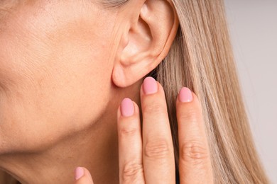 Photo of Woman with healthy skin on light background, closeup