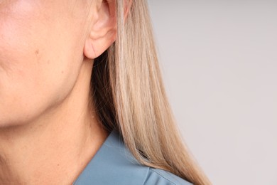Photo of Woman with healthy skin on light background, closeup. Space for text