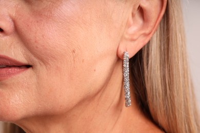 Photo of Closeup view of woman wearing stylish earring