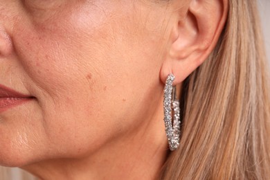 Photo of Closeup view of woman wearing stylish earring