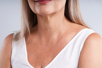 Photo of Woman with healthy skin on light background, closeup
