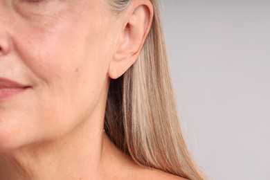 Photo of Woman with healthy skin on light background, closeup. Space for text