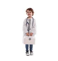 Photo of Choice of profession. Little boy with stethoscope and first aid kit pretending to be doctor on white background