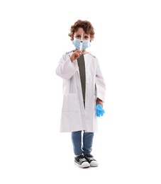 Photo of Choice of profession. Little boy in medical mask with syringe and glove pretending to be doctor on white background