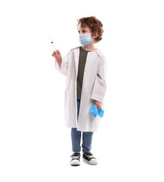 Photo of Choice of profession. Little boy in medical mask with syringe and glove pretending to be doctor on white background