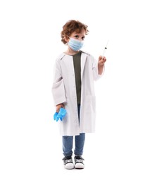 Photo of Choice of profession. Little boy in medical mask with syringe and glove pretending to be doctor on white background