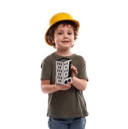Photo of Choice of profession. Little kid in hard hat with house model pretending to be engineer on white background