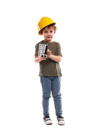 Photo of Choice of profession. Little kid in hard hat with house model pretending to be engineer on white background