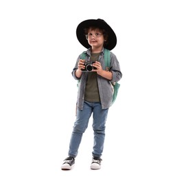 Photo of Choice of profession. Little boy in hat with camera pretending to be photographer on white background