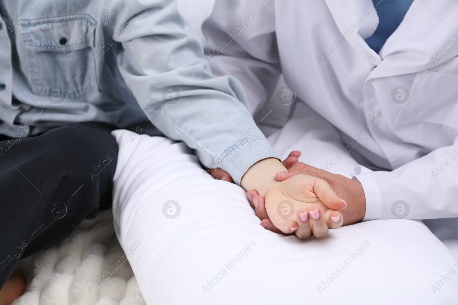 Photo of Doctor checking woman's pulse with fingers at home, closeup