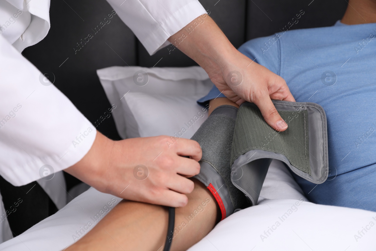 Doctor checking man's heart rate and blood pressure via sphygmomanometer at home, closeup Photo of Doctor checking man's heart rate and blood pressure via sphygmomanometer at home, closeup