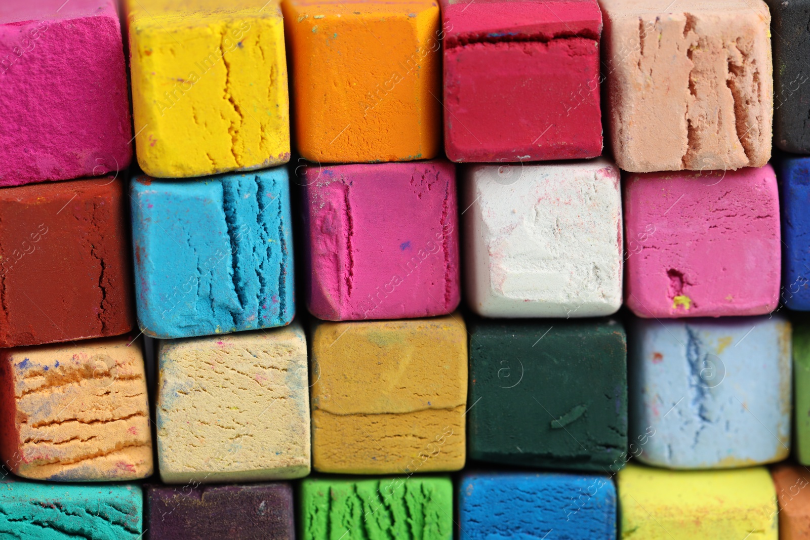 Photo of Many colorful chalk pastels as background, closeup