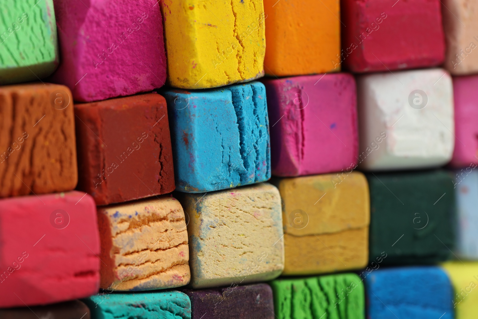 Photo of Many colorful chalk pastels as background, closeup