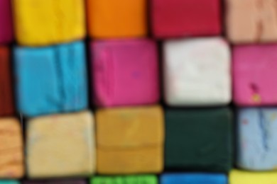 Photo of Many colorful chalk pastels as background, closeup