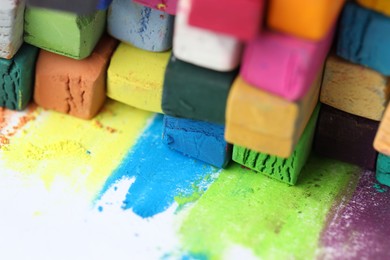 Photo of Many colorful chalk pastels on white background, closeup