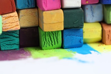 Photo of Many colorful chalk pastels on white background, closeup