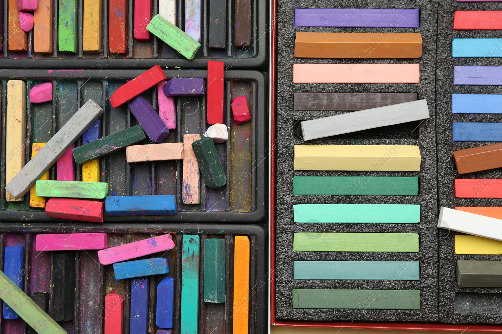 Photo of Set of colorful chalk pastels as background, closeup