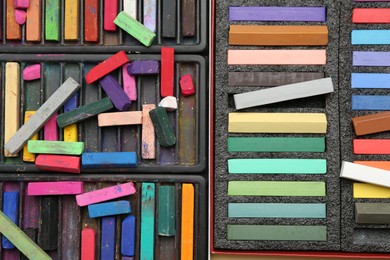 Photo of Set of colorful chalk pastels as background, closeup