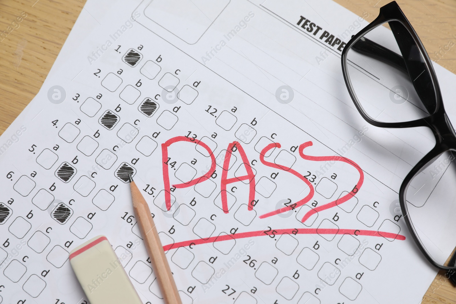 Answer sheet with word Pass, eraser, pencil and glasses on table, top view. Student passing exam Photo of Answer sheet with word Pass, eraser, pencil and glasses on table, top view. Student passing exam