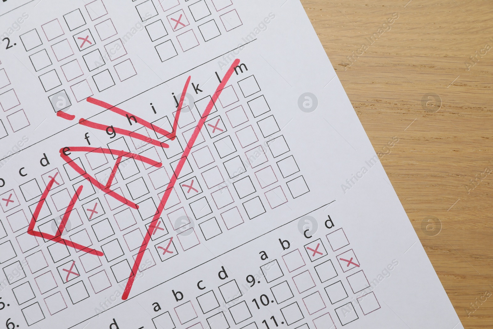 Photo of Answer sheet with word Fail on wooden table, top view. Student passing exam
